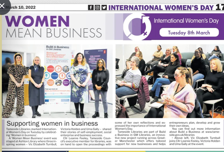 a clipping from an online newspaper. The article's headline is 'women mean business' and the photo is four women standing in front of pull up banners