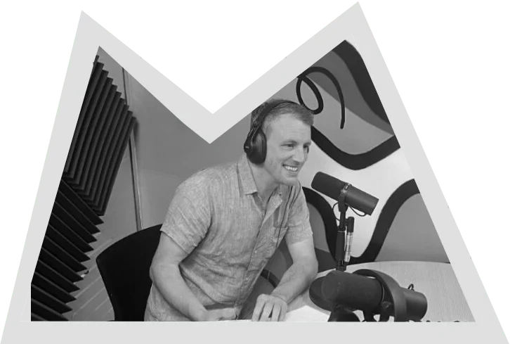 a man wearing headphones speaks into a microphone