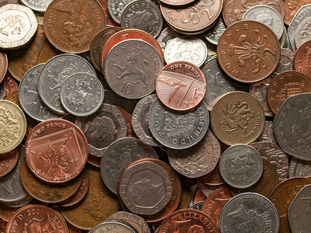 Pile of mixed coins viewed from above.
