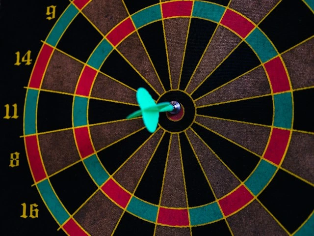 a dart board with a blue dart in the bullseye
